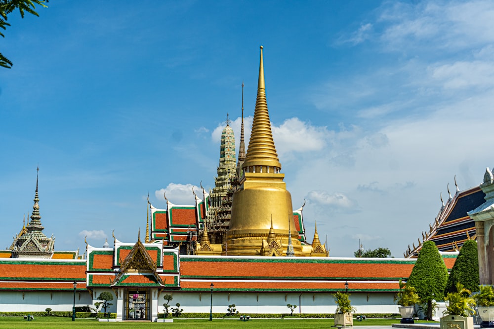 gold and red temple under blue sky