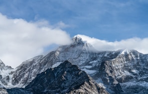 A majestic mountain range under a clear blue sky.