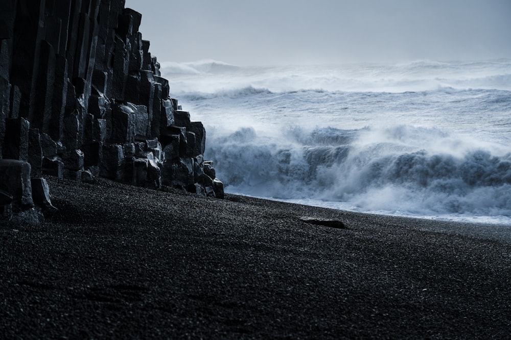 rocky mountain near sea waves