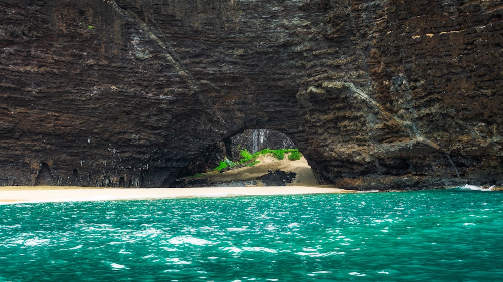 brown rock formation near body of water during daytime