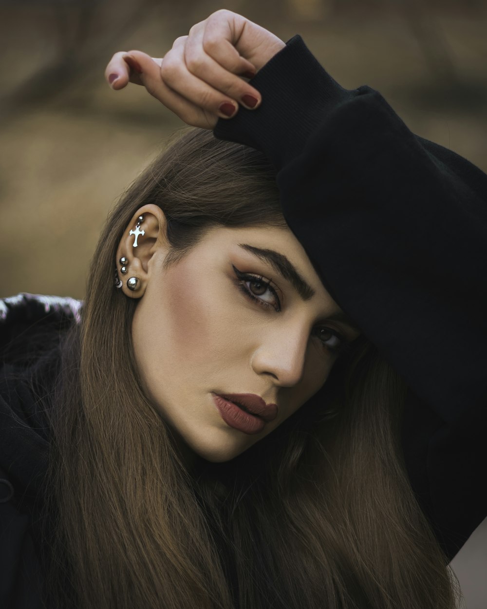 woman in black hoodie wearing silver earrings
