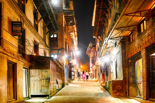 people walking on street during night time in Bhaktapur Nepal