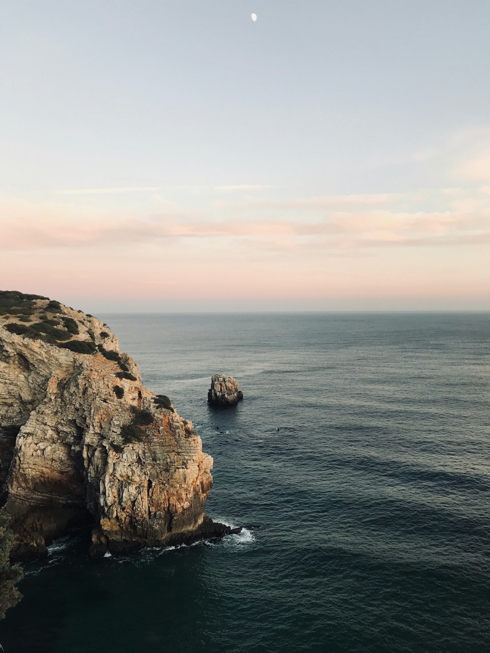 brown rock formation on sea during daytime