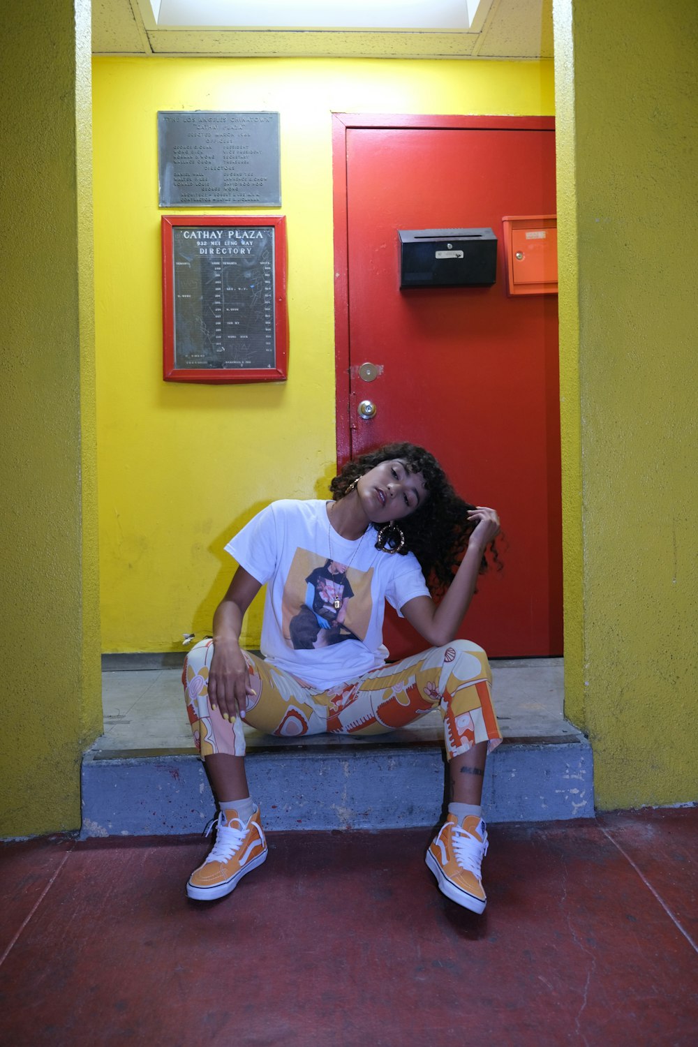 woman in white t-shirt sitting on concrete bench