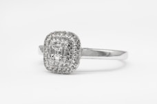 silver diamond studded ring on white surface