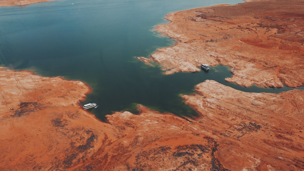 aerial view of brown land near body of water during daytime