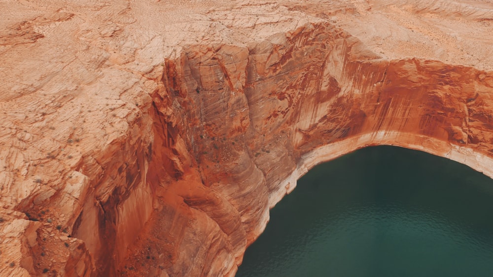 brown rock formation beside blue sea during daytime