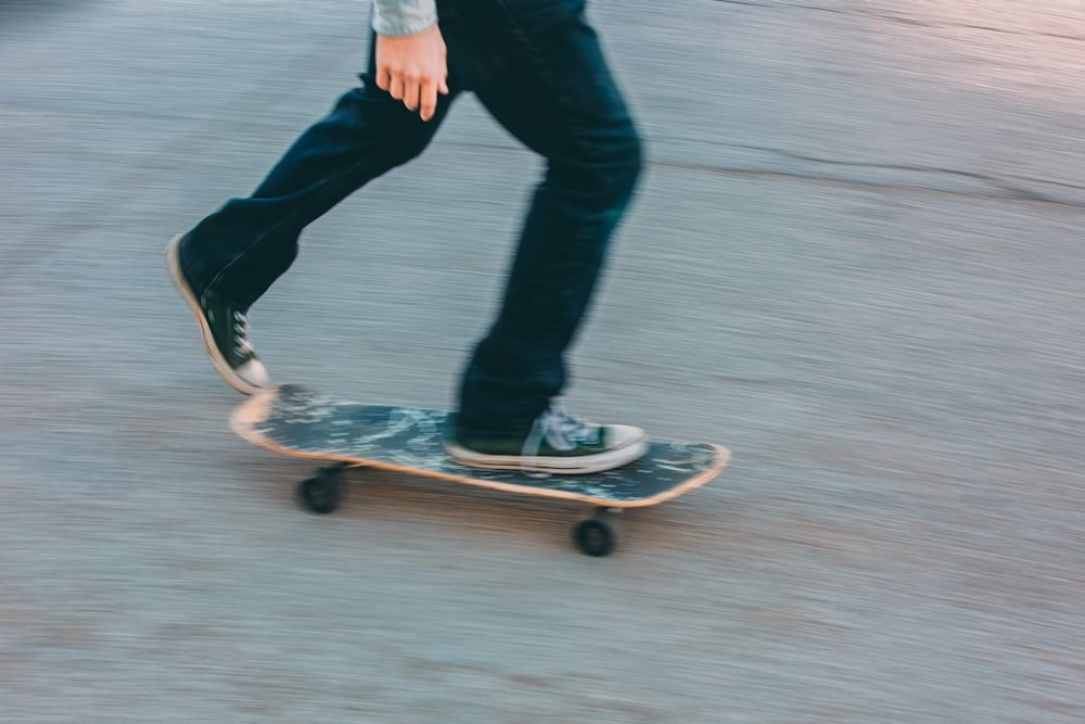 person in black pants riding skateboard