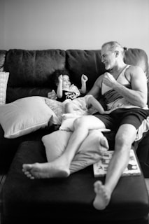 A therapist and child sharing a smile during a playful storytelling session with puppets and soft toys.