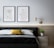 Close-up of a modern minimalist framed wall art hanging above a neatly made bed.