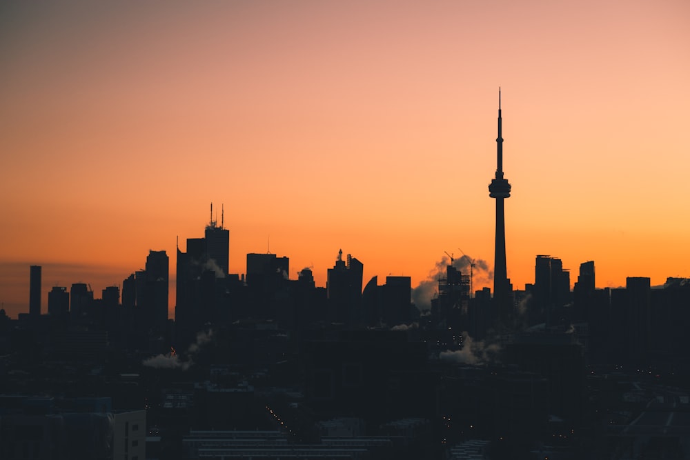 silhouette of city buildings during sunset