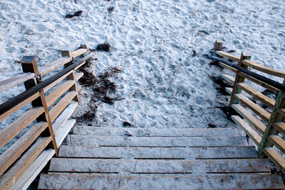 brown wooden stairs on snow covered ground