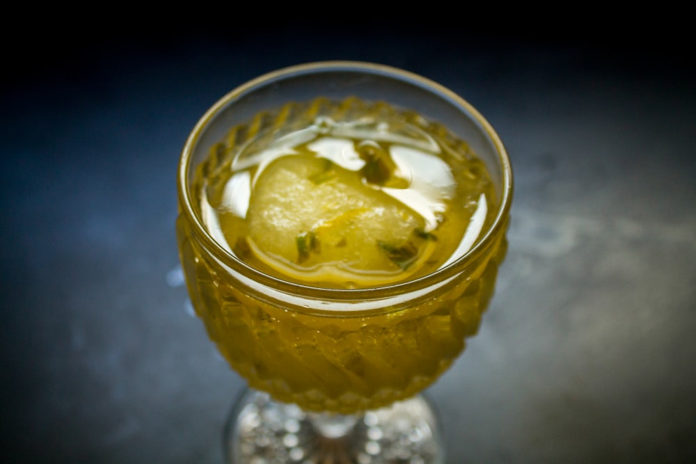 clear glass cup with yellow liquid