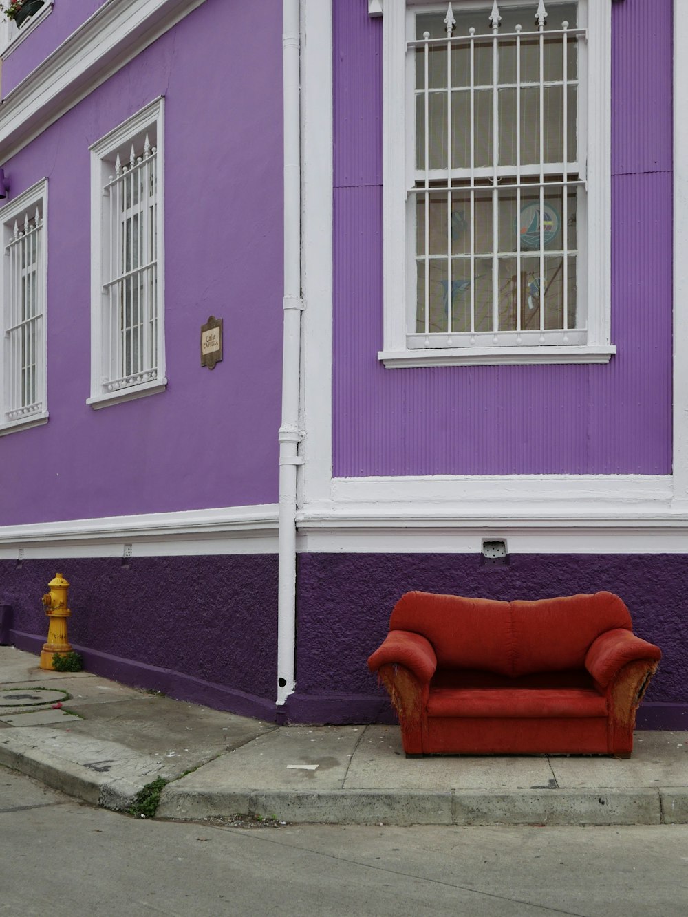 red sofa chair near purple painted wall