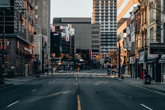 cars parked on side of the road near high rise buildings during daytime in London Canada