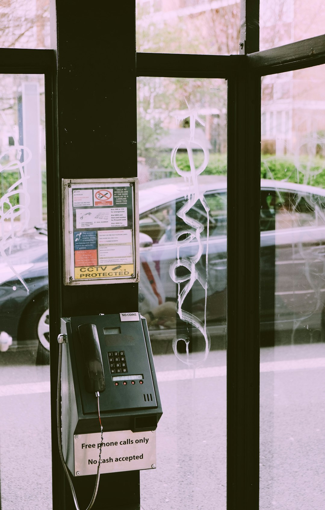 black ip phone on glass window