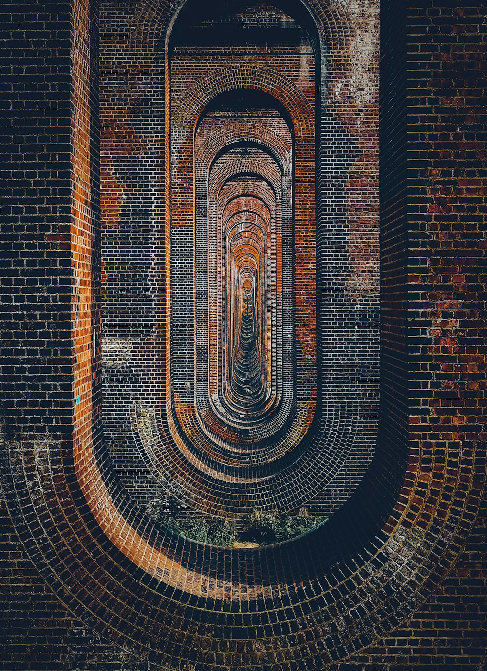 brown brick wall with brown metal tunnel