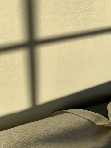 white textile beside white wall