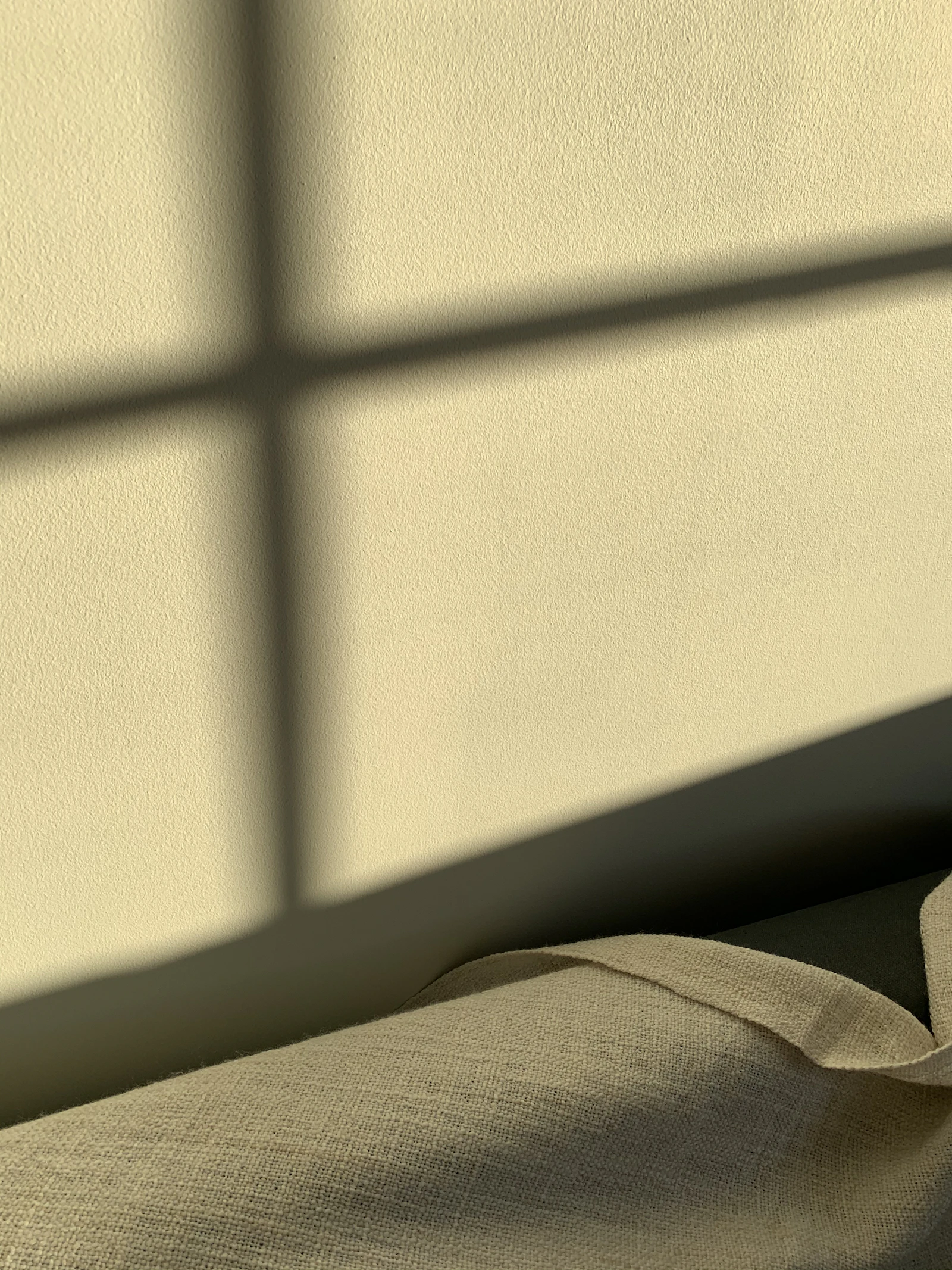 White textile beside white wall