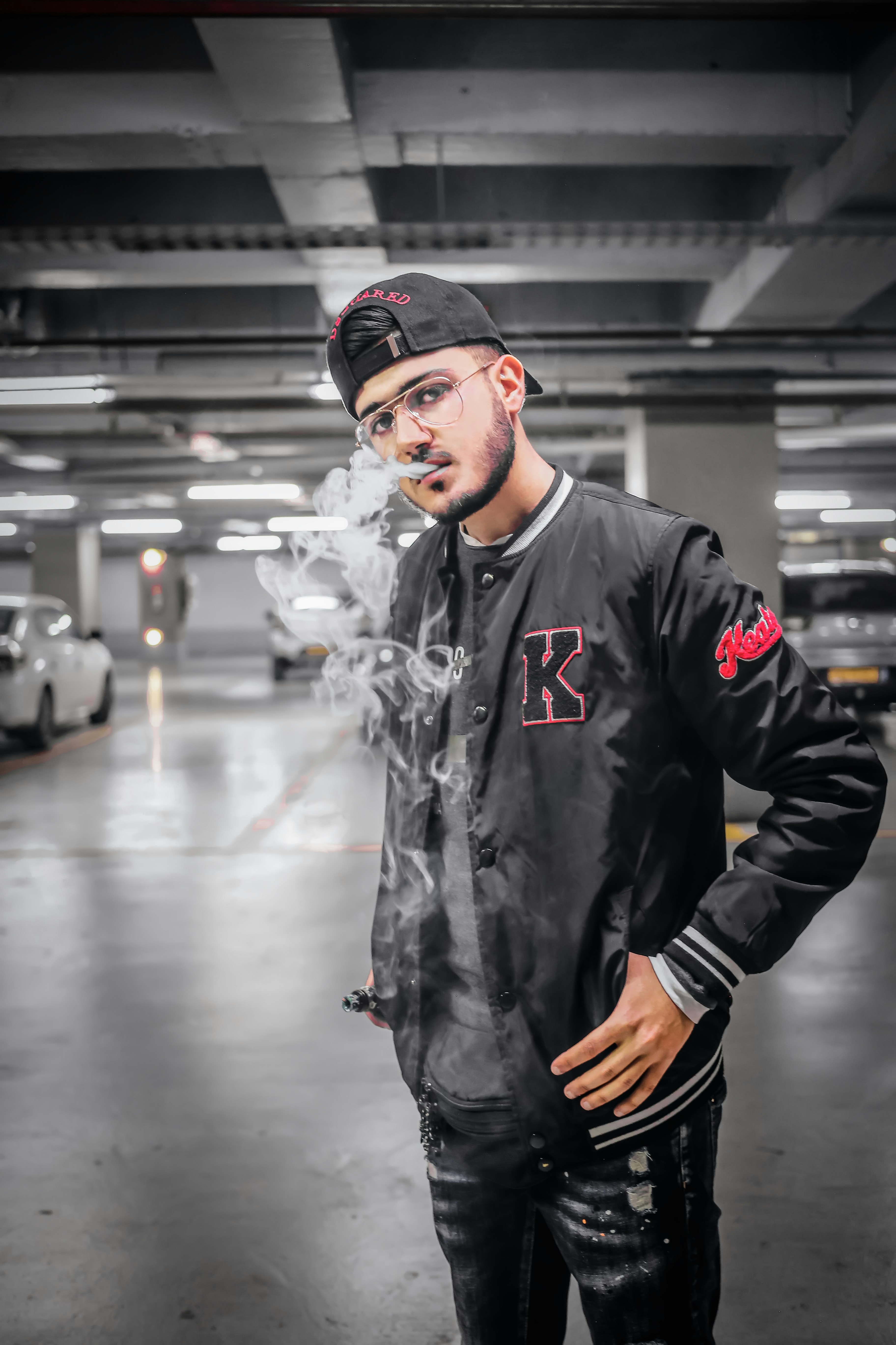 man in black leather jacket wearing black cap