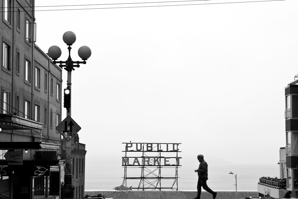 man and woman walking on street near building during daytime