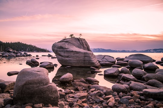 gray rock formation on body of water during daytime in Lake Tahoe United States