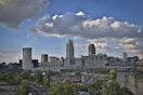 city skyline under blue and white sunny cloudy sky during daytime