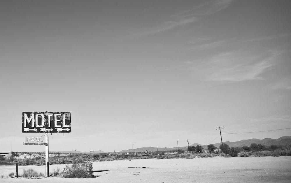 grayscale photo of a road sign