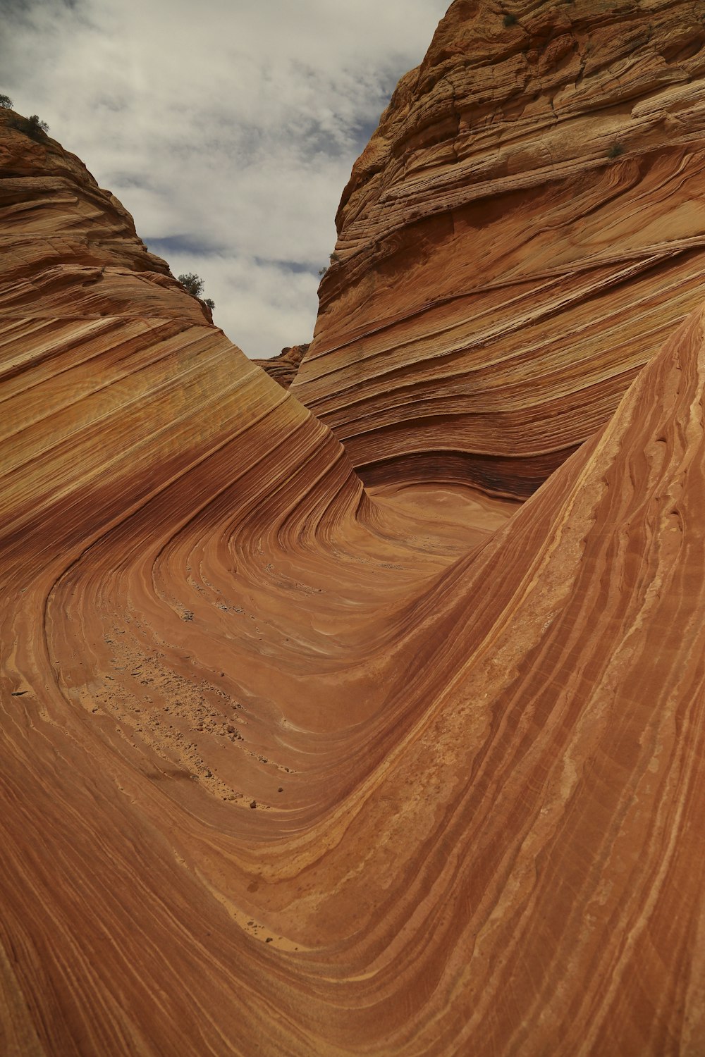 brown rock formation under white clouds during daytime