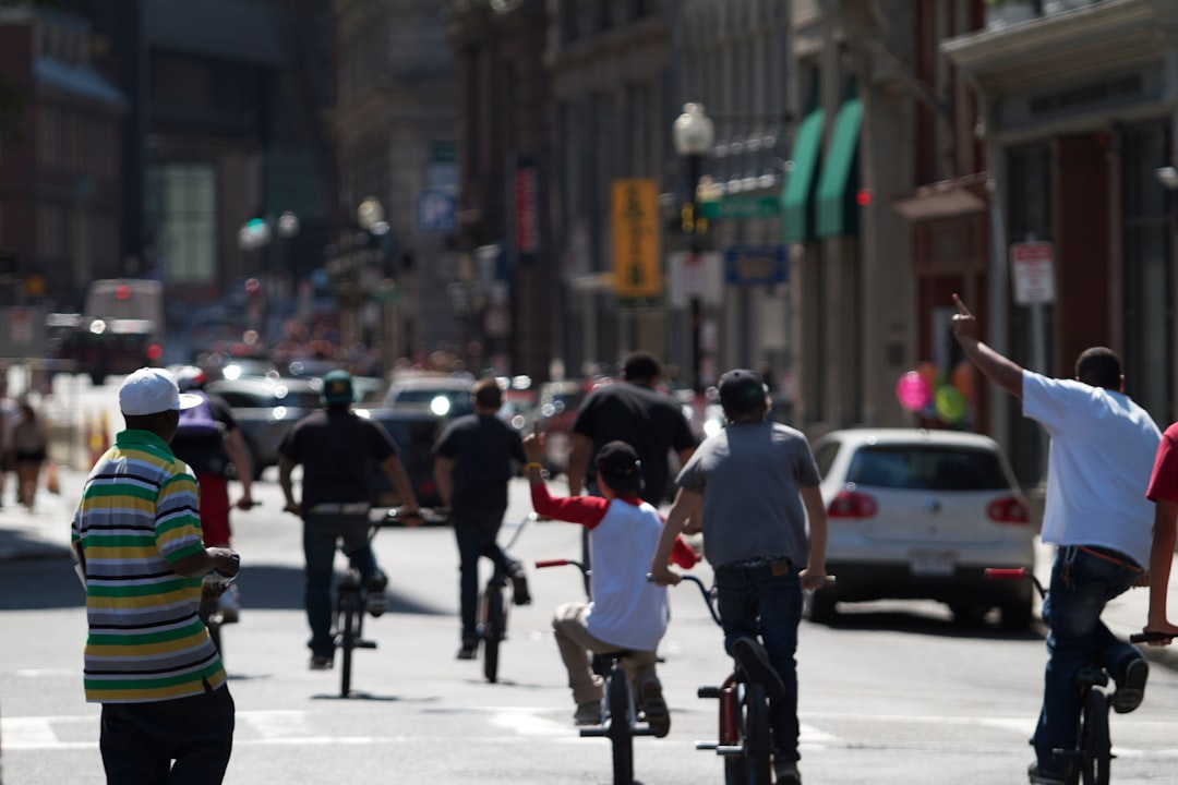 people riding bicycle on road during daytime