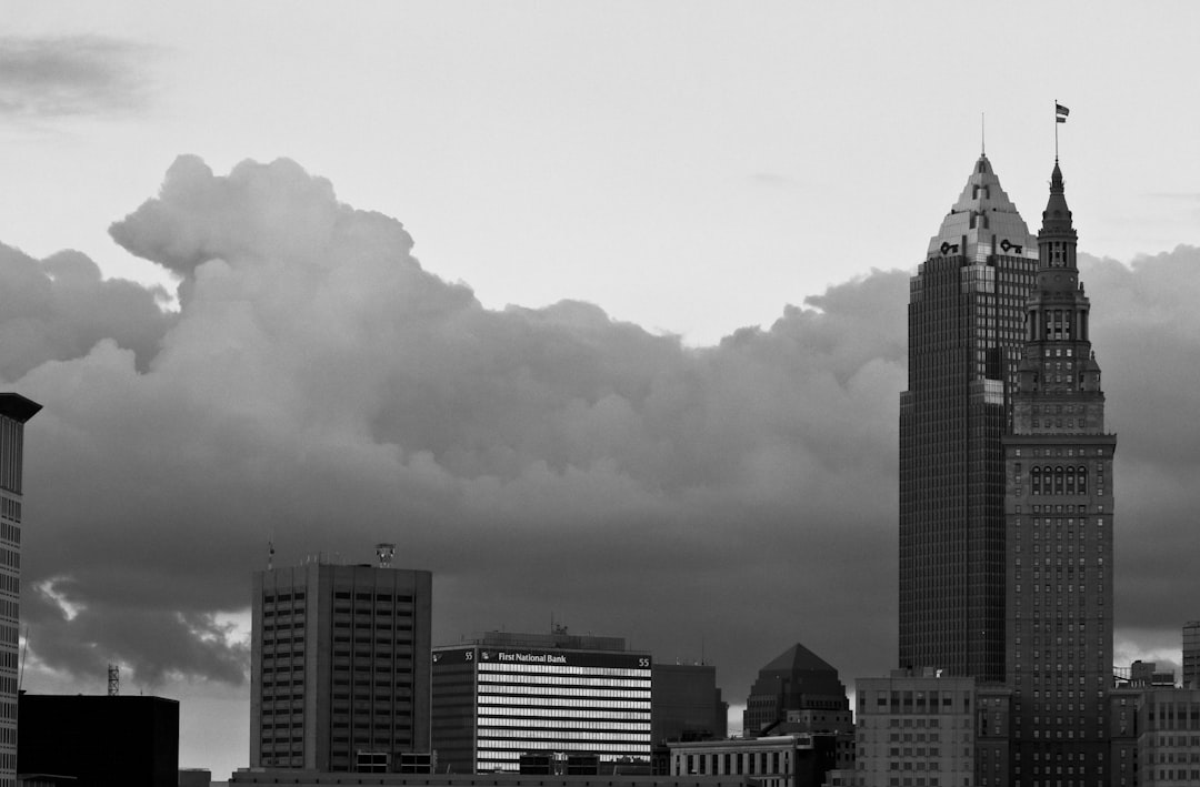 grayscale photo of city buildings under cloudy sky