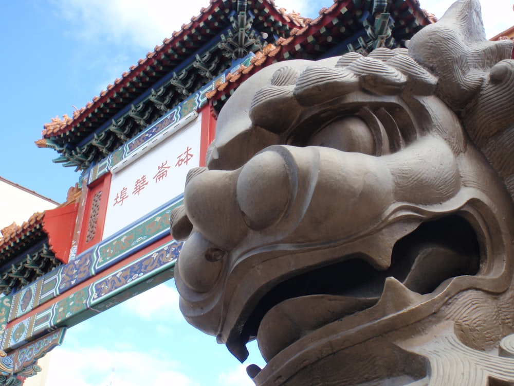 brown concrete statue under blue sky during daytime