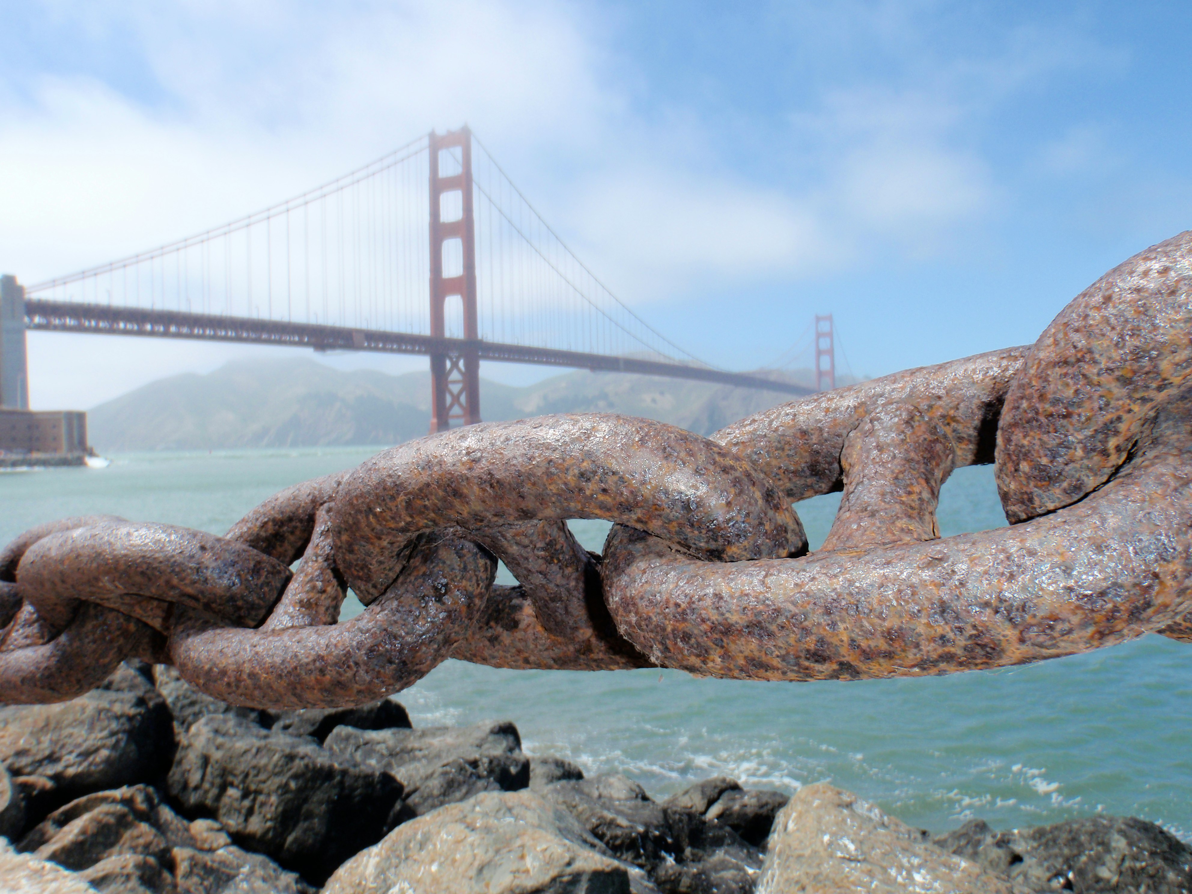 brown metal chain on rocky shore during daytime