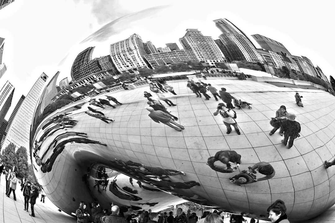 grayscale photo of people in cloud gate