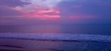 A tranquil beach at sunset with gentle waves lapping.