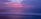 A tranquil beach scene at sunset with gentle waves.
