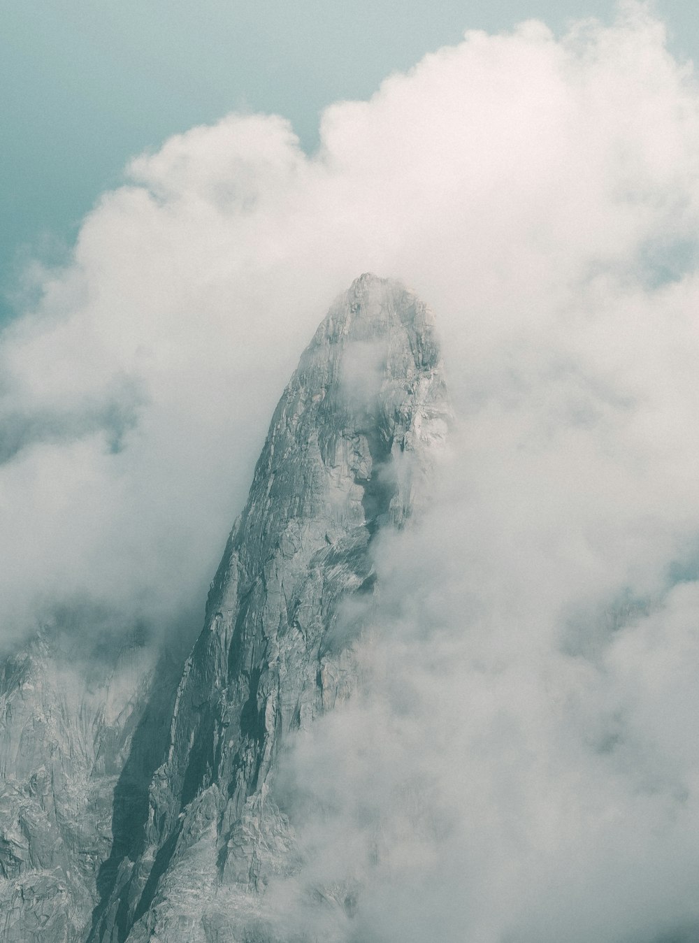 snow covered mountain under white clouds