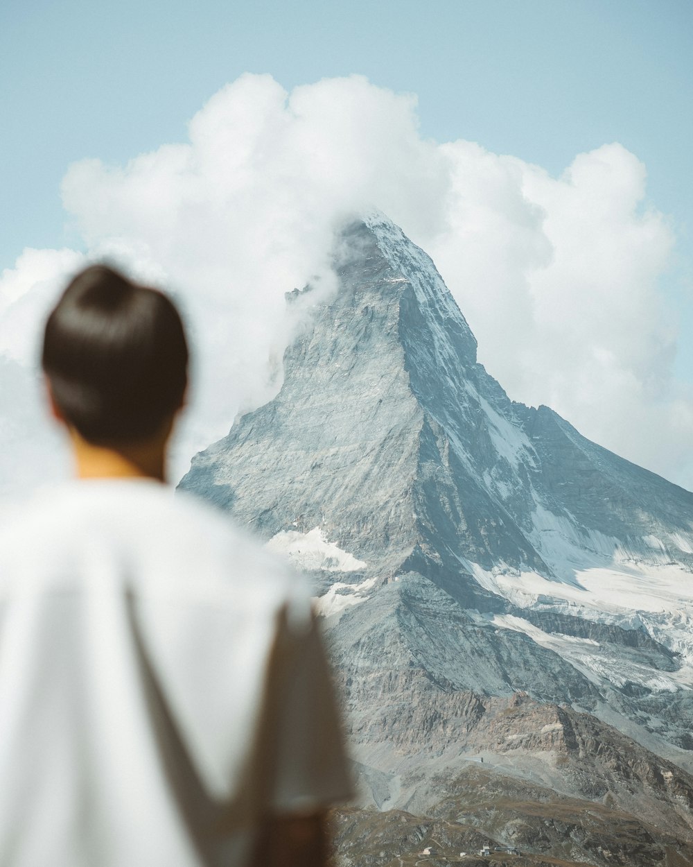 man in white shirt looking at mountain