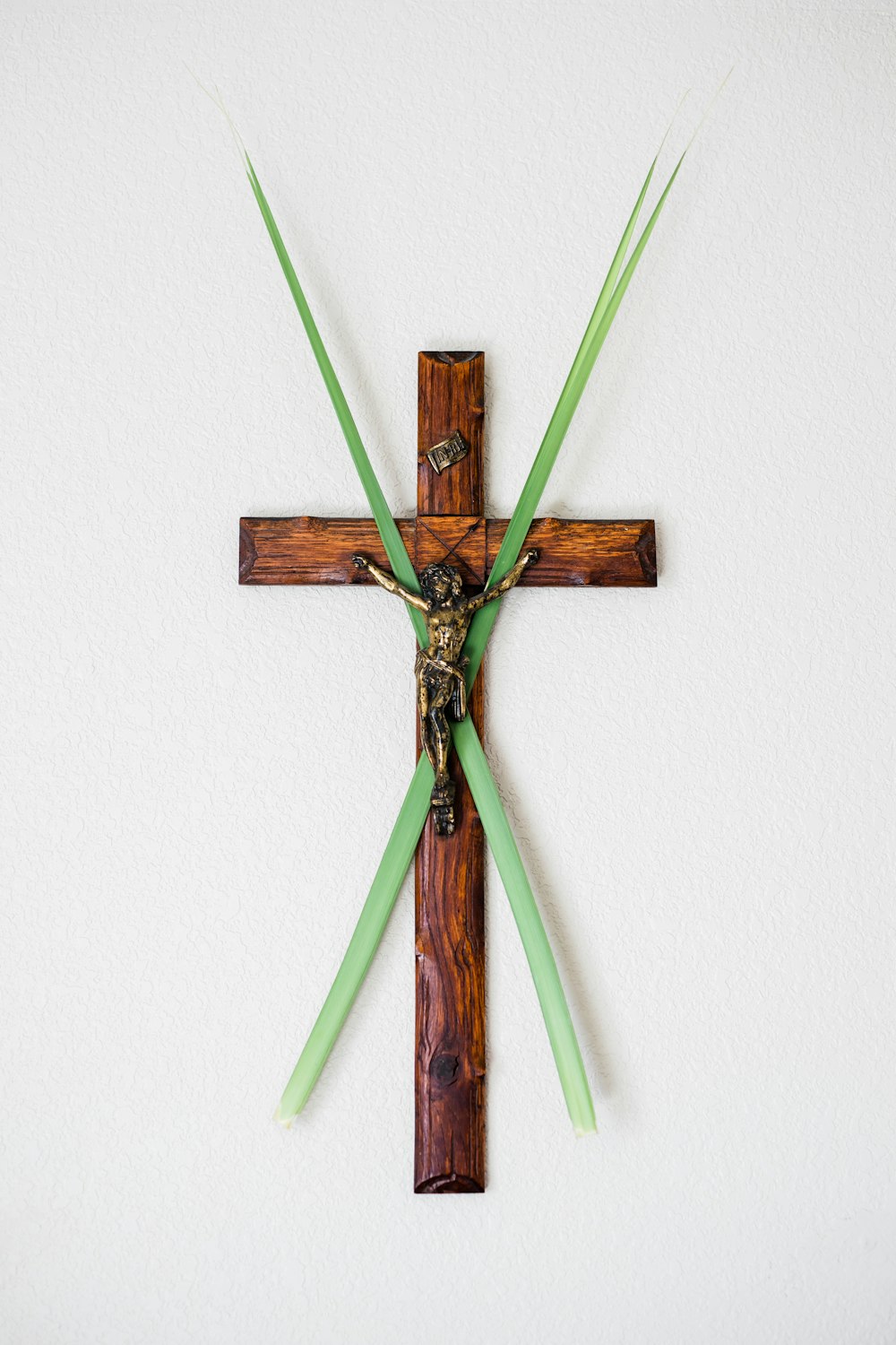 brown wooden cross wall decor