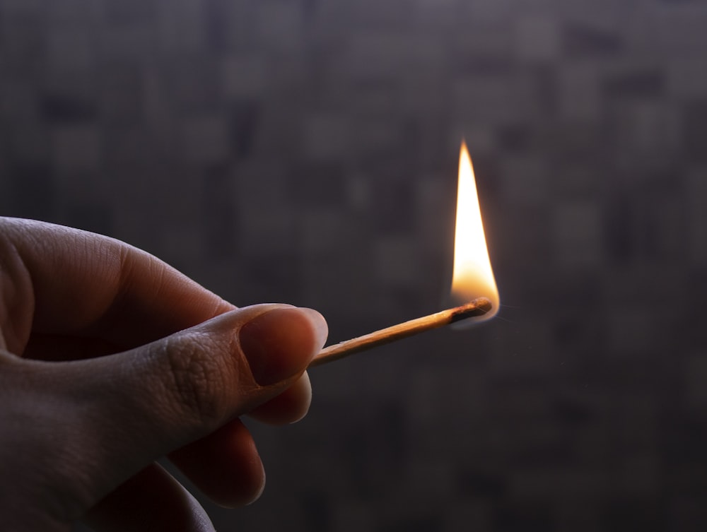 person holding lighted match stick