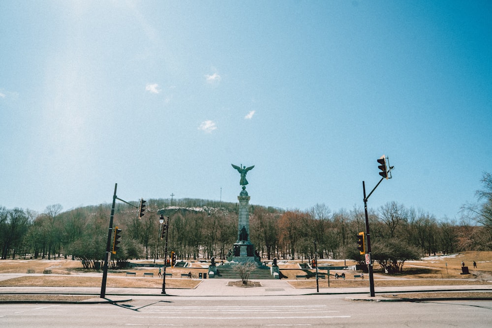 green and brown statue under blue sky during daytime