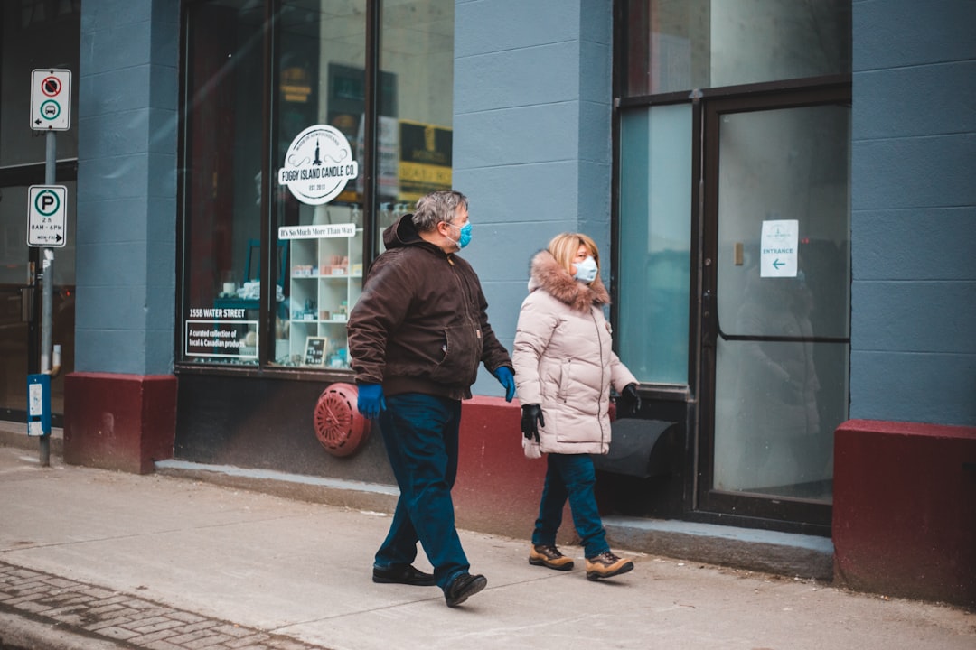 2 women and man standing near store during daytime