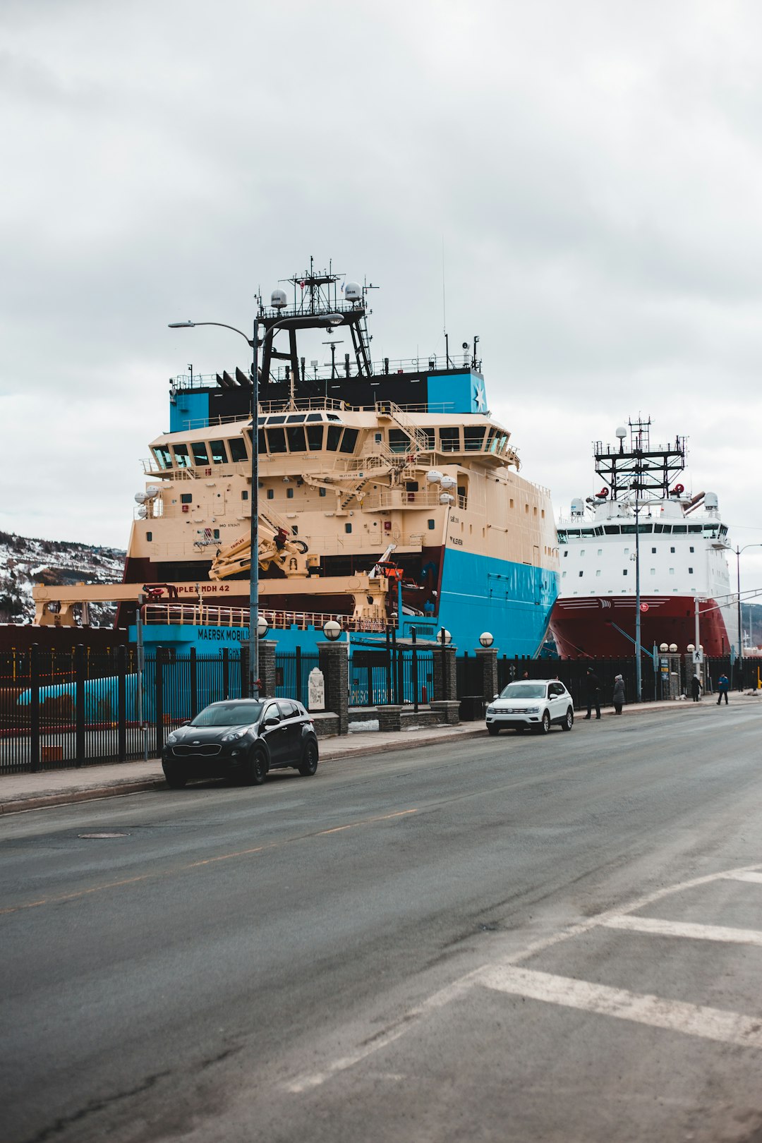 blue and white ship on dock during daytime