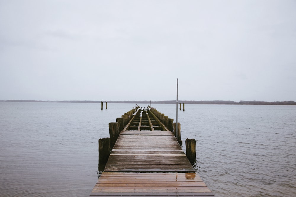 brown wooden dock on sea during daytime