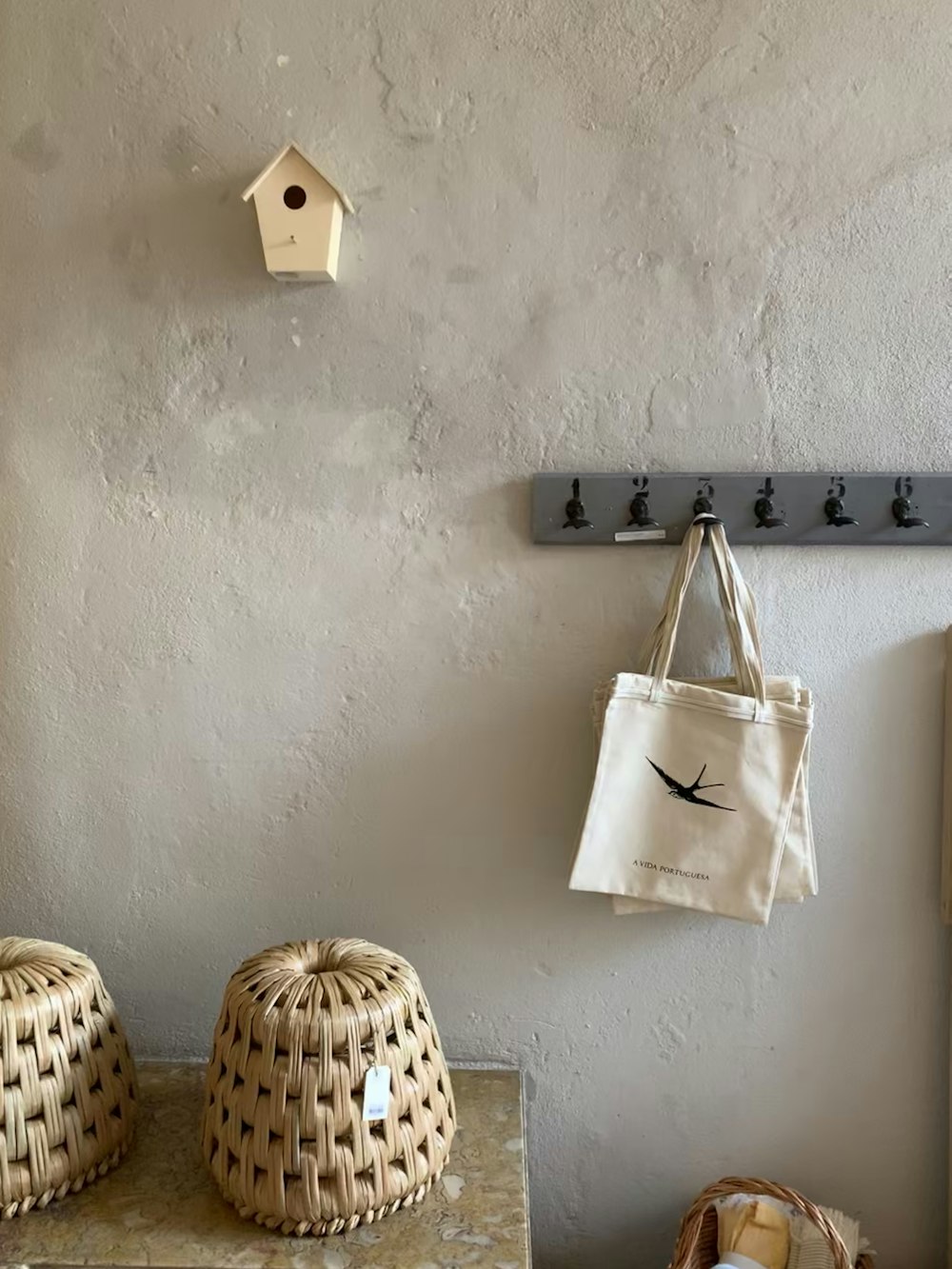 white leather tote bag hanged on white wall
