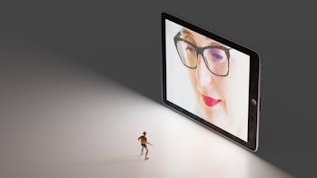 black framed eyeglasses on white table