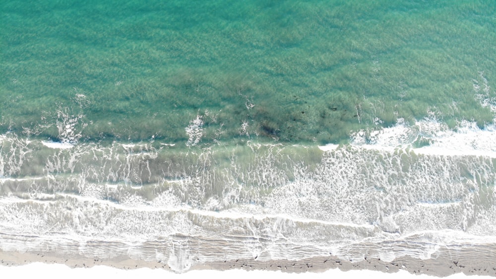 aerial view of green and white ocean waves