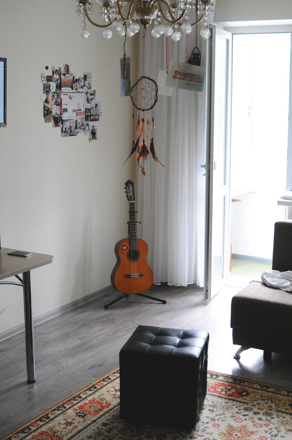 brown acoustic guitar on wall