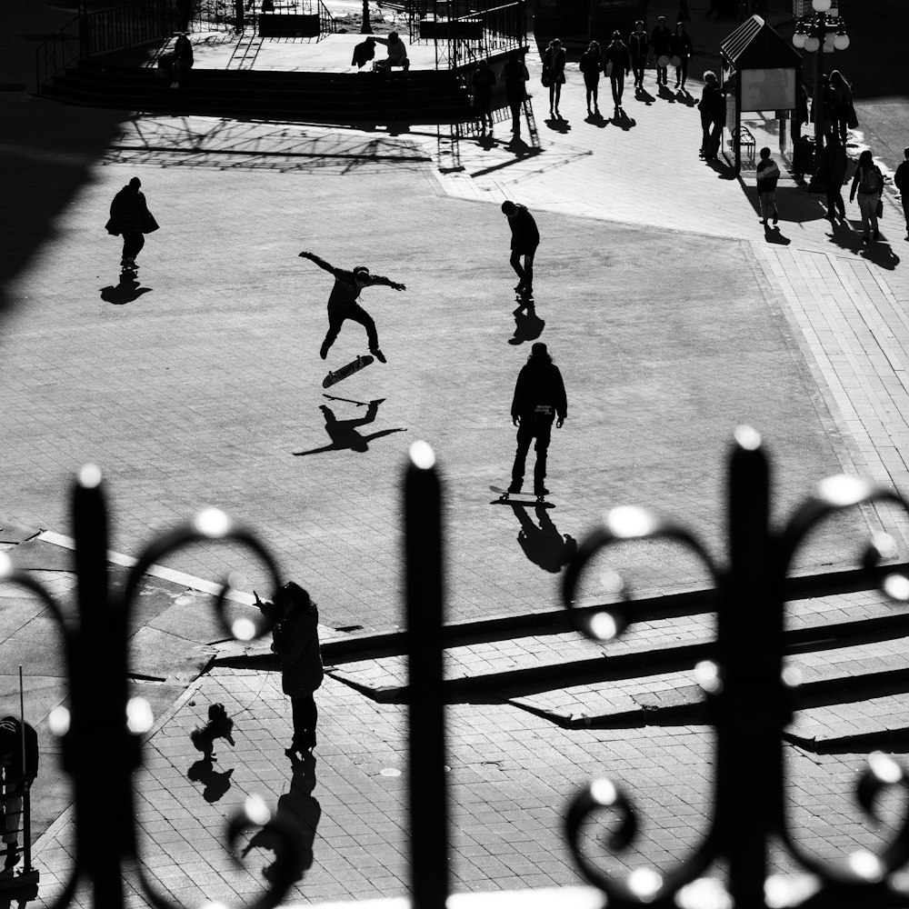 grayscale photo of people playing basketball