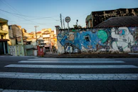 A roadside scene blending urban elements with subtle cosmic imagery in the background.